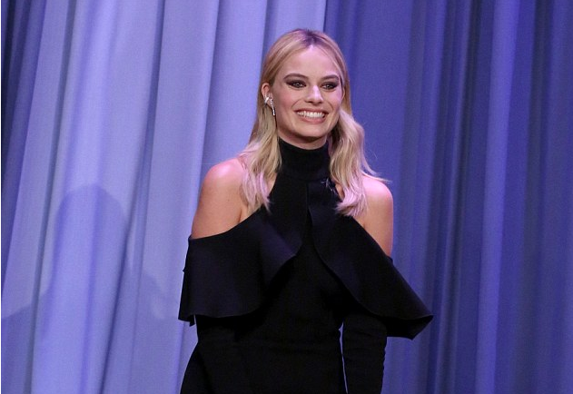 Margot Robbie averts wardrobe malfunction in VERY short black mini with flared sleeves as she stops by Tonight Show