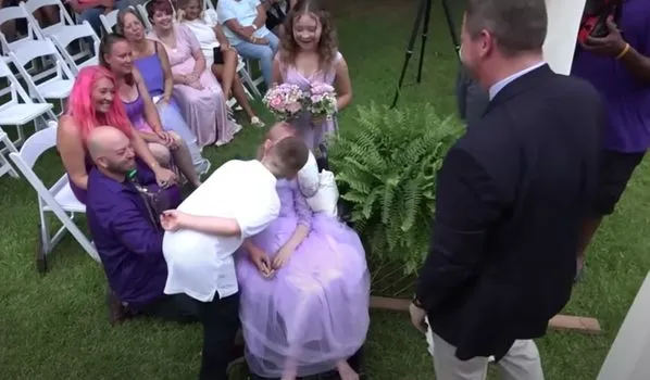 Brave little girl wheeled down the aisle by dad to marry school sweetheart days before passing away