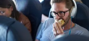 P2. Man wonders if he’s a jerk for eating burger next to vegetarian during flight