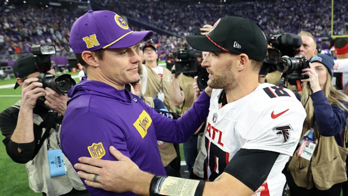 Vikings players and fans embrace Kirk Cousins after their win over the Falcons