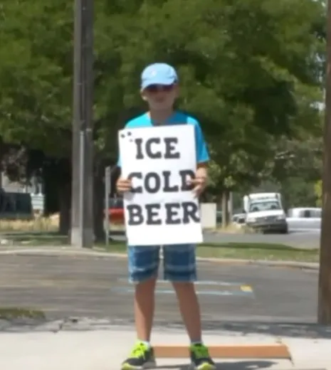 Cops Called On Boy Selling 'Ice Cold Beer', Burst Out Laughing When They Look Closer At Sign