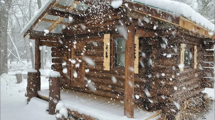 Overnight stay without electricity in a chilly, icy log cabin in the woods