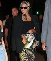 Beyoncé catches the eye in green patterned trousers and a matching headscarf as she enjoys dinner with Jay-Z in New York