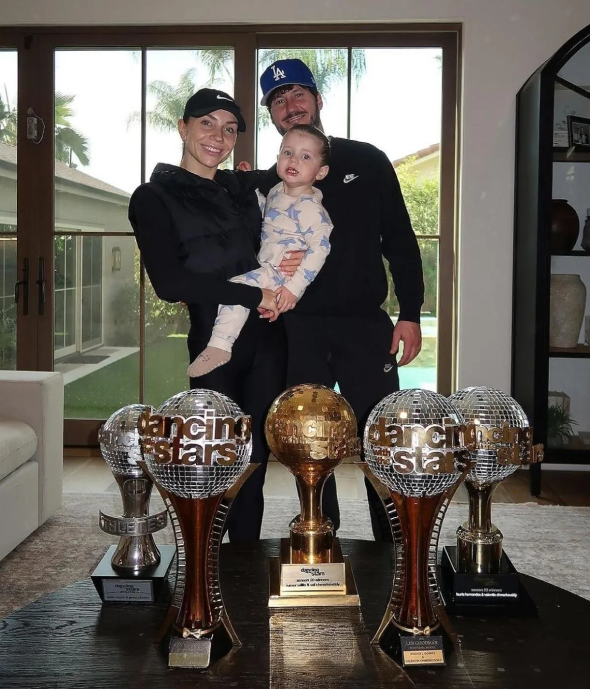Jenna Johnson and Val Chmerkovskiy's son Rome poses with their Mirrorball trophies