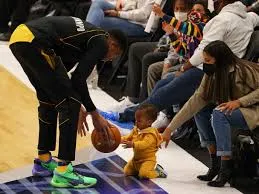 Giannis took over social media when TNT cameras quickly caught the 26-year-old Milwaukee Bucks star and his two sons dribbling the ball to each other just before the game started