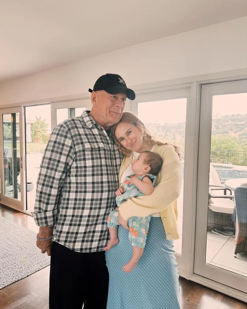 Bruce Willis holding his granddaughter today at his daughter Rumer’s home.