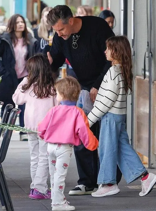 Daddy duty! The Bachelor's Sam Wood is every inch the doting father as he juggles his three young daughters during an outing in Melbourne