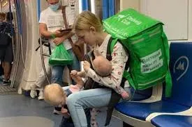Photos of a young mother working as a courier in Moscow spark renewed calls for help — and fraud allegations