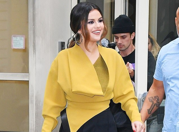 Selena Gomez looks business chic in unique mustard blazer with tailored trousers on press tour in New York