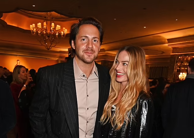 Margot Robbie gazes adoringly at husband Tom Ackerley as they make a rare public appearance at swanky Oscars reception in London