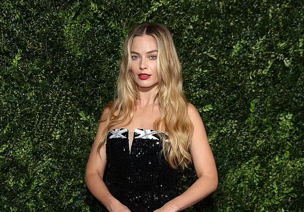 Margot Robbie puts on a leggy display in a sequinned black mini dress as she attends star studded 2024 Pre-BAFTA Party