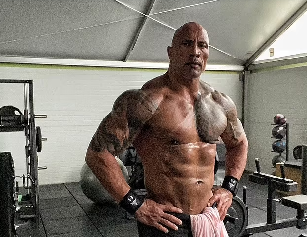 Dwayne 'The Rock' Johnson indulges in a hefty 'cheat meal' including two large burgers and a bottle of TEQUILA after his workout